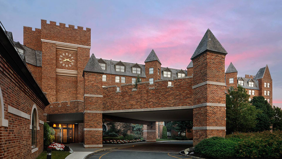 Dolce by Wyndham Parsippany hotel exterior at dusk